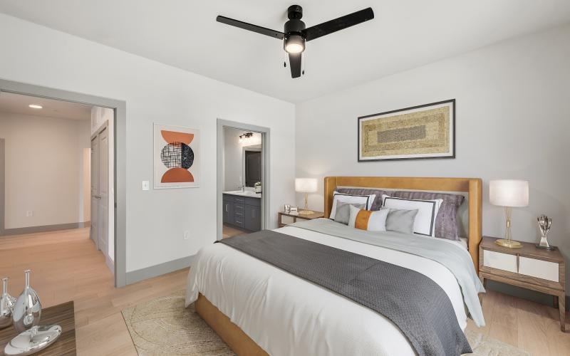 a bedroom with a bed and a fan